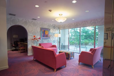 Bright common area with pink couches and large windows