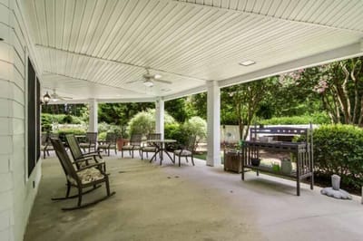Covered outdoor patio area with seating