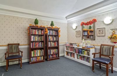 Cozy library corner with bookshelves and autumn decorations