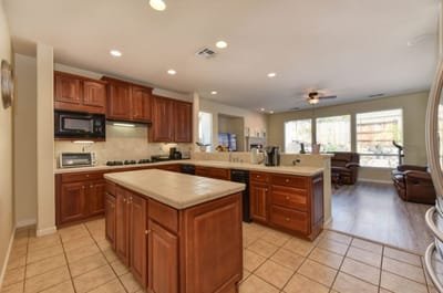 Interior kitchen space with wooden cabinetry and seating area