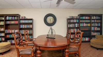 Cozy reading area with bookshelves and a large clock