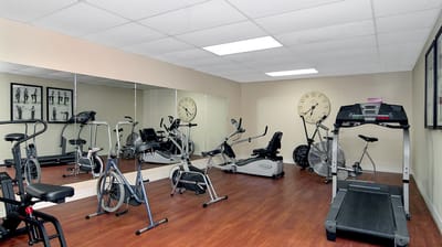 Fitness room with exercise equipment and mirrors
