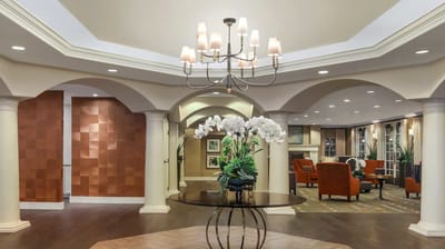 Interior view of a bright, spacious common area with plants