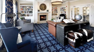 Cozy common area with bookshelves and a fireplace