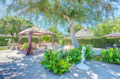 Garden area with seating and gazebo in bright sunlight