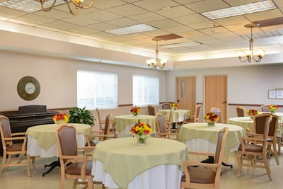 Bright dining area with floral centerpieces and tables