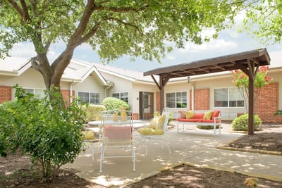 Outdoor seating area with trees and light decor