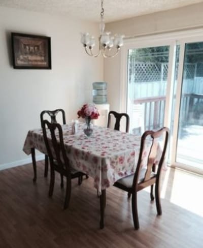 Cozy dining area with a floral tablecloth and water cooler