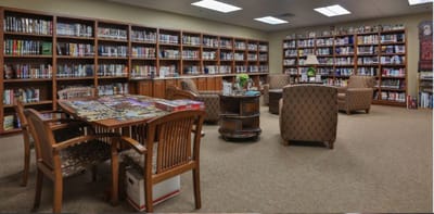 A cozy library room with bookshelves and seating