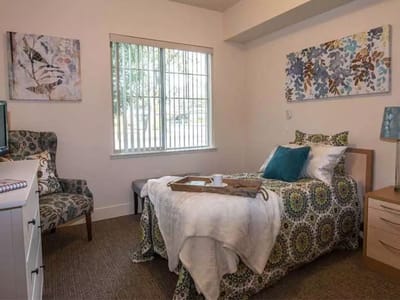 Cozy private room with a bed and chair