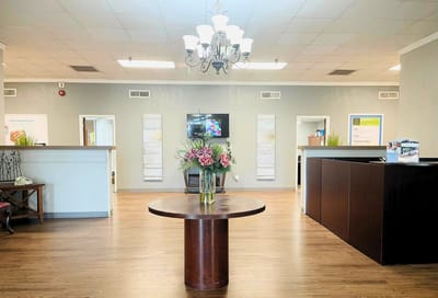 Interior lobby with a reception desk and floral arrangement