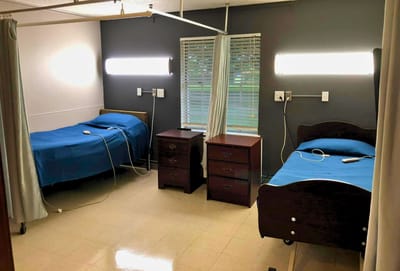 Private resident room with two beds and furnishings