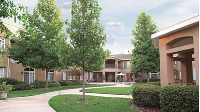 Outdoor area of a senior living facility with gardens and seating
