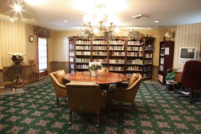 A cozy library with bookshelves and seating