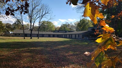 Exterior view of Riverside Lifelong Health facility with autumn foliage