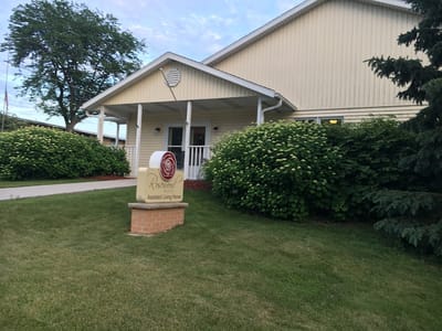 Exterior view of Rosewood Manor with entrance and sign