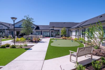 Outdoor space with green putting area and benches