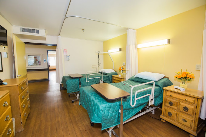 A shared resident room with two beds and decor