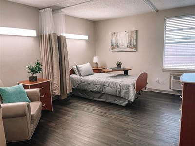 Cozy resident room with bed and chair