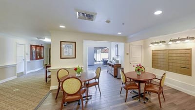 Bright interior common area with tables and flowers