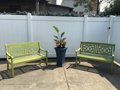 Outdoor seating area with benches and flowers