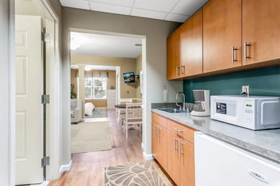 Interior of a resident room with kitchenette and seating area