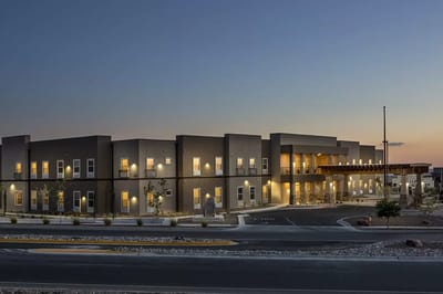 Exterior view of a modern assisted living facility at dusk