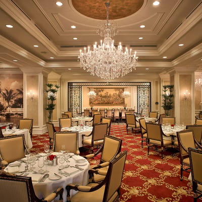 Elegant dining room with chandeliers and fine table settings