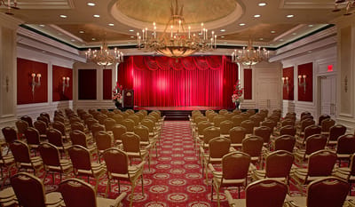Elegant interior space with a stage and seating