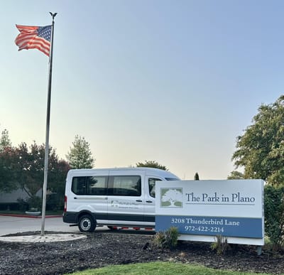 Facility exterior with vehicle and flag