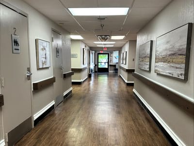 Well-lit interior hallway with artwork