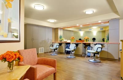 Interior view of a salon with orange flowers.