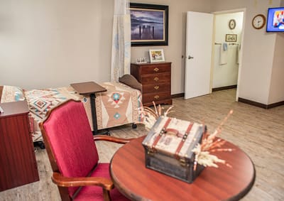Cozy resident room with a bedside table and decorations