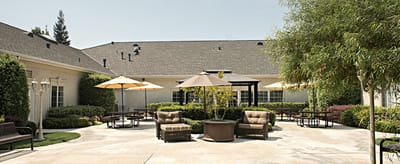 Outdoor seating area with umbrellas and landscaping