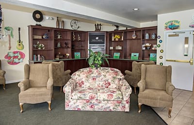 Cozy lobby area with floral couch and bookshelves