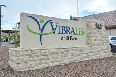 Facility logo on a stone monument sign outside