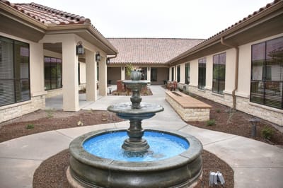 Outdoor courtyard with a fountain and seating area