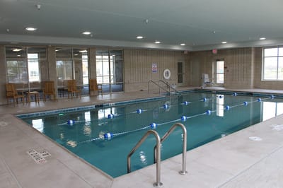 Indoor swimming pool area with seating