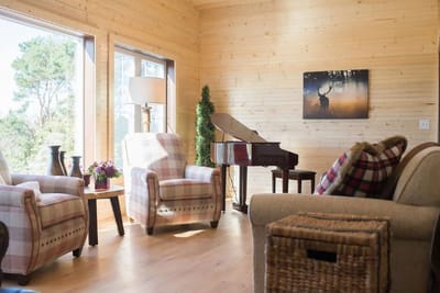 Cozy common area with chairs and a piano
