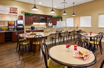 Bright dining area with tables and food on display