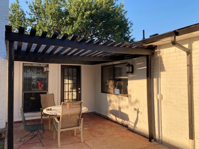 Outdoor patio area with a pergola and seating