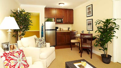 Cozy resident room with kitchenette and seating area