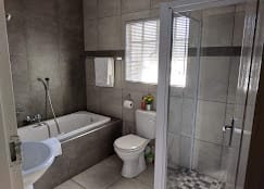 Spacious bathroom with a bathtub and shower.