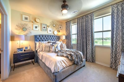 Cozy private bedroom with large windows and decor