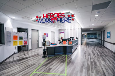Lobby area with welcoming signage and staff member