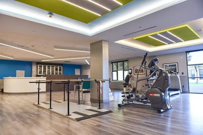 Rehabilitation gym with exercise equipment and therapy bars