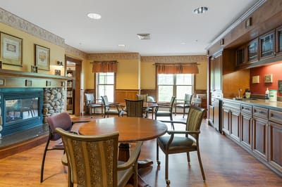 Common area with seating and fireplace in a senior living facility