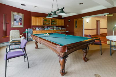 Common area with a pool table and seating arrangements