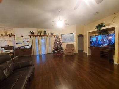 Common area with a Christmas tree and large TV