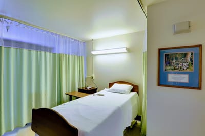 A private resident room with a bed and desk